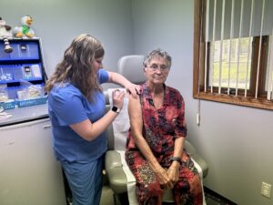 Woman receives COVID vaccine from nurse